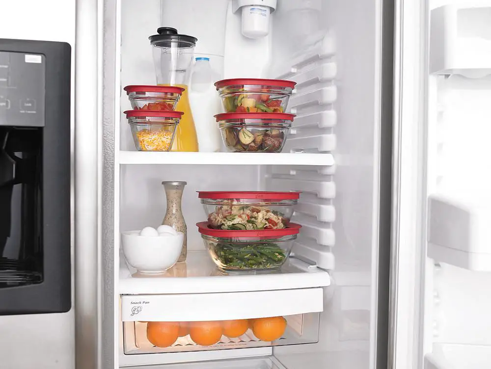Assorted healthy meal prepped lunches stored in glass containers in a refrigerator