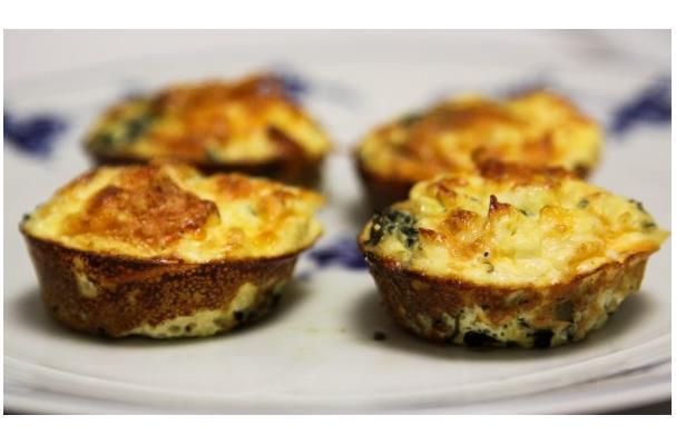 Mini frittata muffins made with eggs, cheese, and chopped vegetables in a muffin tin